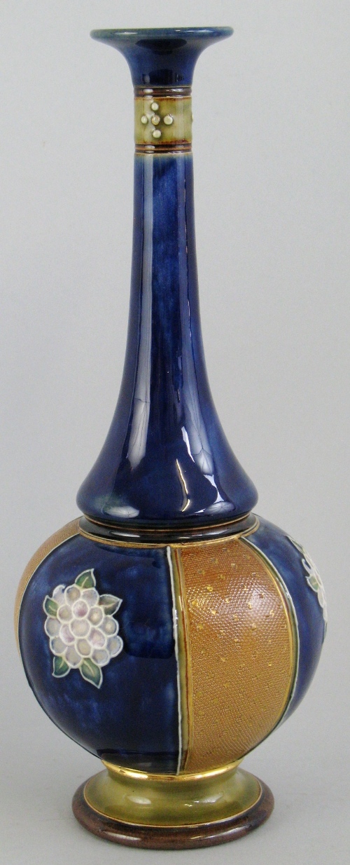 A Royal Doulton stoneware vase, of bottle shaped form with alternate fish scale and flowerhead