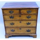 A 19th Century oak chest, the moulded edged oblong top over two short and three long cock beaded
