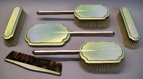 A six piece brush set, comprising hand mirror, pair of hair brushes, pair of clothes brushes and