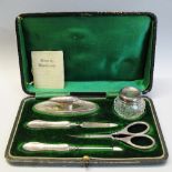A five piece manicure set, in fitted case comprising buffer, glass pot, file and cuticle pusher,