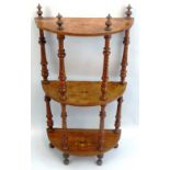 A Victorian walnut whatnot, with three inlaid semi circular tiers on turned and incised supports