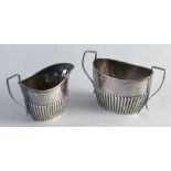 A Victorian sugar bowl, of two handled oval form with half reeded body, initialled, 12cm wide,