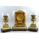 An early 20th century French brass garniture de cheminee, the clock with brass eight day movement