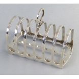 An Edwardian toast rack, with seven arched bars and loop handle, 12.5cm wide Sheffield 1909 4.75ozs