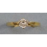 A solitaire diamond ring, having raised claw setting on a gold shank marked 18ct, size O