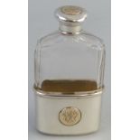 A Victorian hip flask, the facetted clear glass body with screw top and removable half cover/