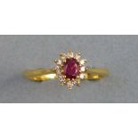 A ruby and diamond cluster ring, on an 18ct gold shank, size N