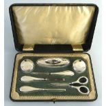 A seven piece manicure set, comprising two lidded jars, buffer, file, tweezers, cuticle pusher and