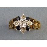 A sapphire and diamond floral cluster ring, with four sapphires and five diamonds set on a 9ct