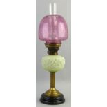 A Victorian table oil lamp, with black glazed ceramic base, brass reeded column stem, moulded opaque