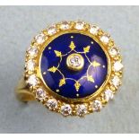 A diamond ring, with central raised solitaire stone on a blue enamel ground bordered by nineteen