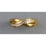 A diamond ring, with twelve channel set diamonds in a crossover setting on 14ct gold shank, size M