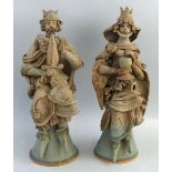 Hilary Brock, pair of stoneware figures of a King and Queen modelled seated on goblet style thrones,