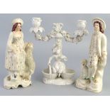 A pair of Victorian Staffordshire figures, of a shepherd and shepherdess, he standing with one