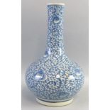 A Chinese vase, of bottle shaped form painted all over in blue and white with flower heads amongst