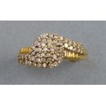 A diamond cluster ring, with multi-stone scroll style setting on 18ct gold shank, size N