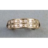 A diamond ring, having two rows of eight channel set diamonds on 18ct white gold shank, size S