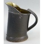 Walter Keeler, a salt glazed stoneware jug with reeded strap work handle and grey/green finish,