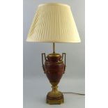 A 20th century French table lamp, as a gilt brass and oxblood marble two handled urn, 39cm high