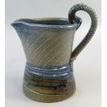 Jane Hamlyn, a salt glazed stoneware jug of waisted form with herringbone handle in green shading to