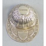 A caddy spoon, in the shape of a jockeys cap with embossed decoration, Sheffield 1982