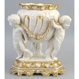 A Victorian Copeland table centrepiece, in the form of three cherubs linked by a leafy garland