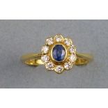 A sapphire and diamond cluster ring, on an 18ct gold shank, size L