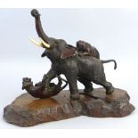 A Japanese Meiji period bronze group, of an elephant and two tigers, one of the tigers on the