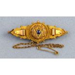 An Edwardian bar brooch, with central sapphire surrounded by diamonds in a star setting on 9ct