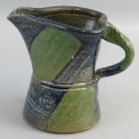 Jane Hamlyn,  a salt glazed stoneware jug of waisted form with rope twist handle in green and