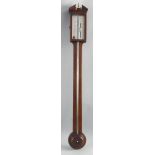 A 19th century mahogany stick barometer, the broken arched pediment with central turned brass finial