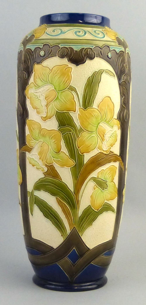 A Burmantofts Faience vase, of ovoid form tube lined with panels of daffodils within brown glazed