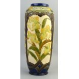 A Burmantofts Faience vase, of ovoid form tube lined with panels of daffodils within brown glazed