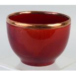 A Bernard Moore bowl, of tapering circular form with Sang-De-Boeuf glaze and applied copper rim,