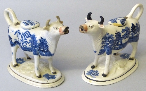 Two 19th century cow creamers, each with tail loop handle and lid, foliate moulded oval base and