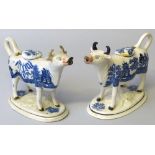 Two 19th century cow creamers, each with tail loop handle and lid, foliate moulded oval base and