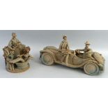 Hilary Brock, a stoneware group as a man seated in a motor car with a lady seated on the bonnet,