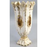 A Coalport pedestal vase, with wavy rim, fluted square tapering body and decorative base with