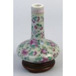 A Chinese vase, of bottle shaped form, enamelled in the famille rose style with flowers and leaves