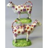 Two 19th century Swansea cow creamers, possibly Cambrian or Glamorgan, each with tail loop handle