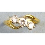 A three-stone diamond ring, the three stones claw set in line at an angle on 18ct gold shank with