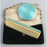 A continental travelling vanity mirror and matching comb slide, the mirror of circular form with