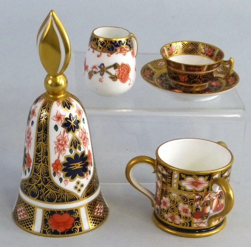 Royal Crown Derby in pattern 1128, bell, miniature cup and saucer, a small jug and a small bulbous
