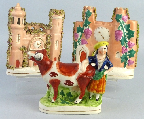 A Victorian Staffordshire flat back cow creamer, modelled standing with a milk maid as the handle,