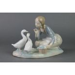 A Lladro figure of a kneeling girl with geese 9", boxedThere is a chip to the leaf being held by the