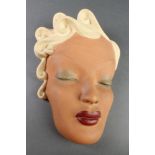 An Art Deco female face mask inscribed Ian Douglas 9"