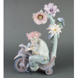 A Lladro figure of a clown riding a tricycle no. 199/1000 decorated by J Ruiz, boxed and with