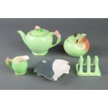 A Royal Grimwades floral teapot and jug, a Carltonware preserve pot and spoon, a 3 bar toast rack
