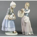 A Lladro figure of a girl with a basket of puppies 10", a ditto of a girl holding a goose 10"Both