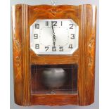 An Art Deco wall clock with 9" lozenge shaped silvered dial contained in an oak case